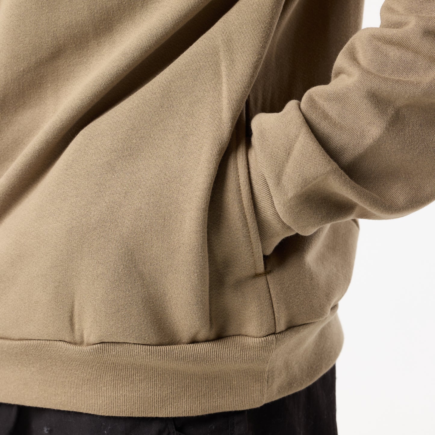 A person wearing the DFND Memphis 1/4 Zip stands with one hand in the pocket, photographed from the side against a plain background—ideal for cold weather training.