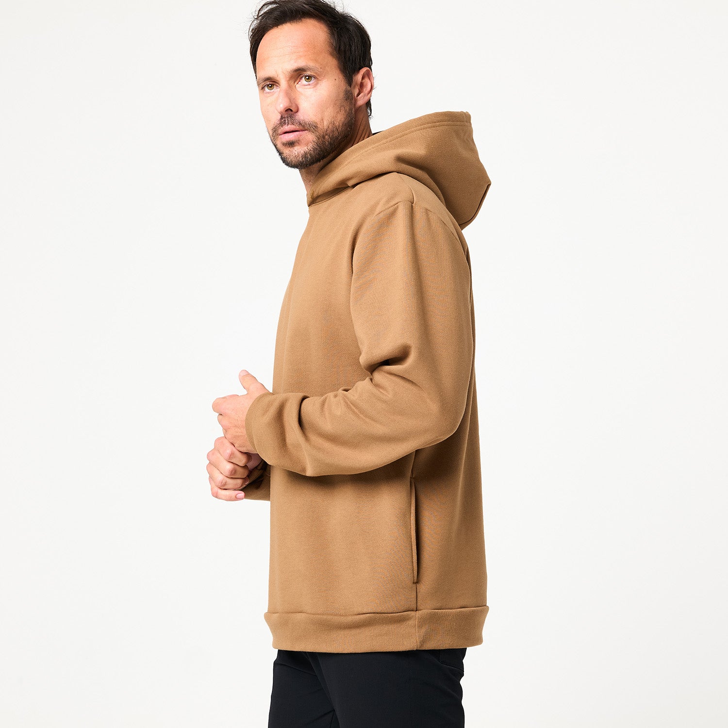 A man wearing the DFND Memphis Fleece Hood and black pants stands sideways against a white background with a neutral expression—perfect for cold weather training.