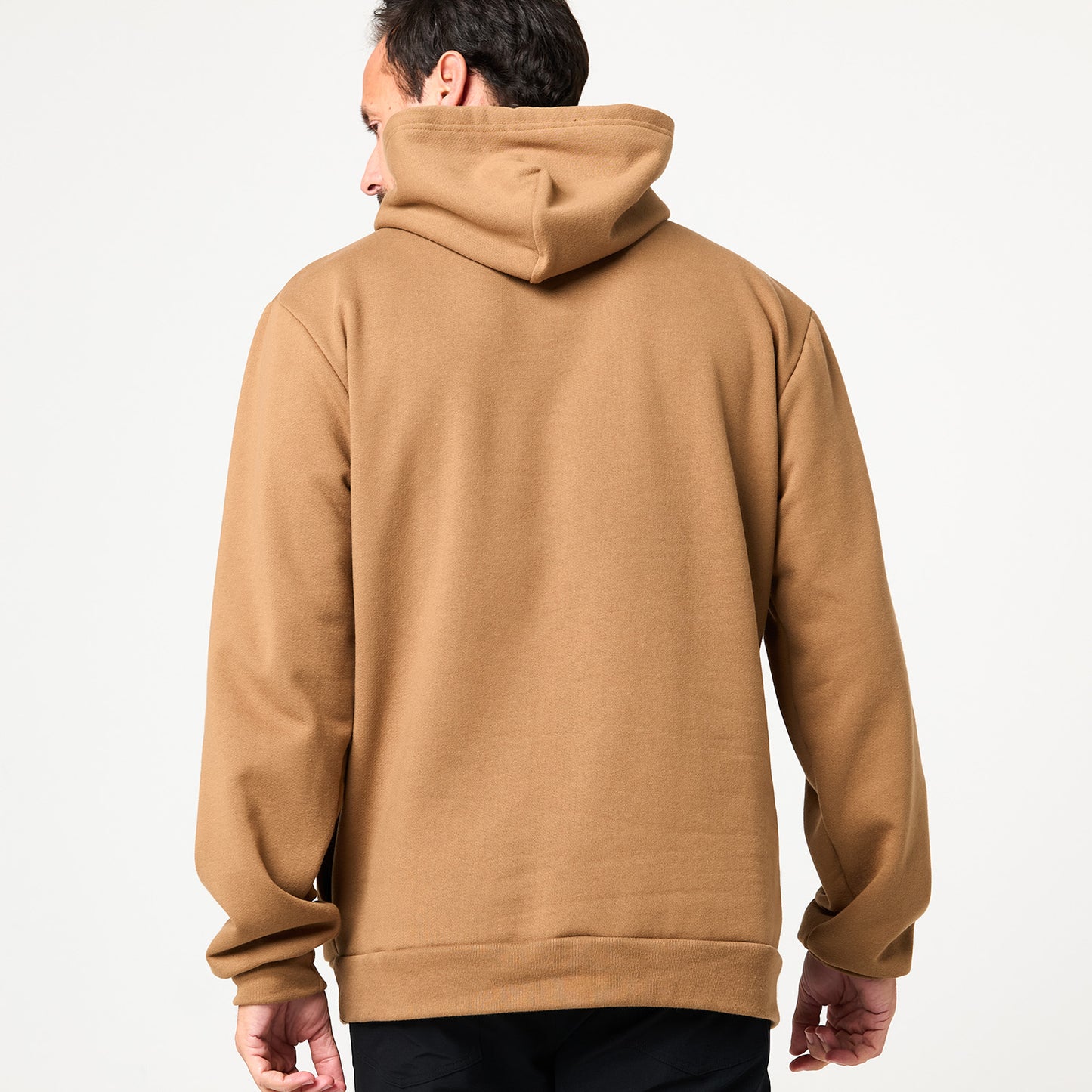 A person is seen from behind wearing a tan DFND Memphis Fleece Hood sweatshirt with the hood down against a plain white background. Made in the USA, it's ideal for cold weather training.