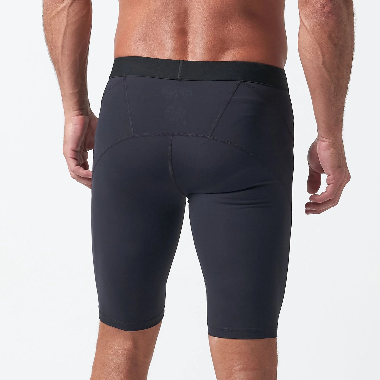 A man is seen from behind wearing the DFND Compression Short + Shirt Gym Kit against a plain light background.