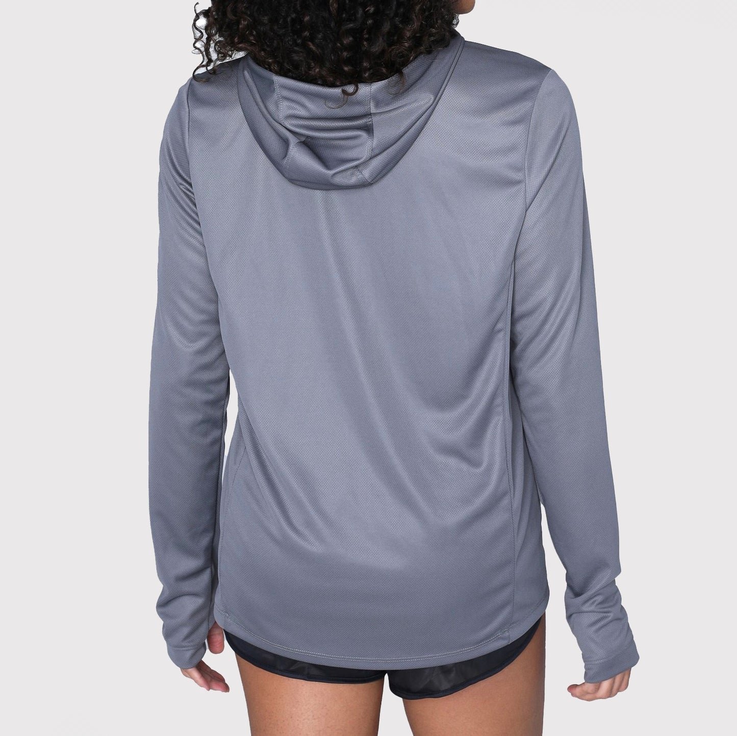 A person is shown from the back wearing the DFND SHIELD HOODED SUN SHIRT in gray, featuring long sleeves and SPF 50+ protection, paired with black shorts against a plain background.