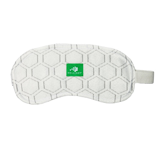 The DFND CELLIANT SOCK AND SLEEP MASK is a white sleep mask with a hexagon pattern, green Celliant logo tag, and an elastic strap on the right side. See part number TR116 for details.