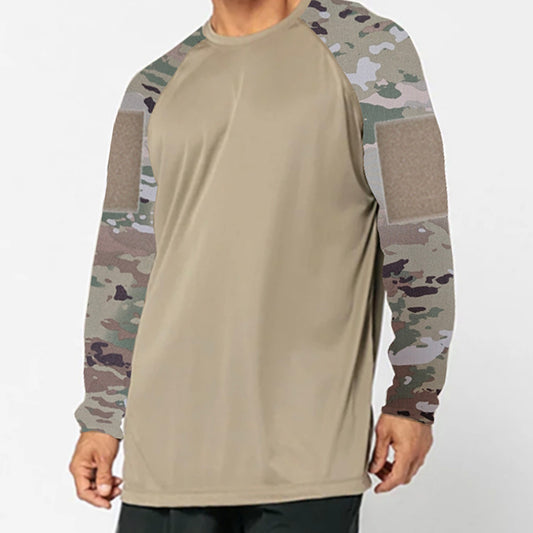A man wears the DFND SPEED TECH LS SHIRT WITH VELCRO, a beige lightweight performance top with camo sleeves, velcro upper arm patches, and moisture-wicking antimicrobial fabric for lasting comfort.