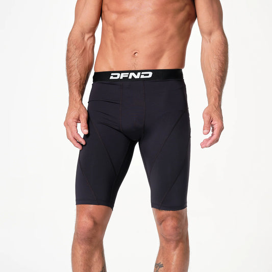 A man models the DFND Compression Short 3-Pack with branded waistband and CELLIANT technology, standing against a plain white background.