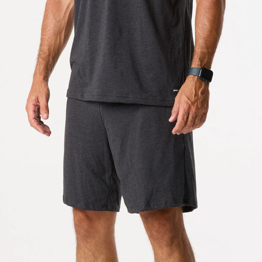 A person wearing a black smartwatch and DFND Sleepwear SS Shirt & Shorts in dark grey stands against a plain white background.