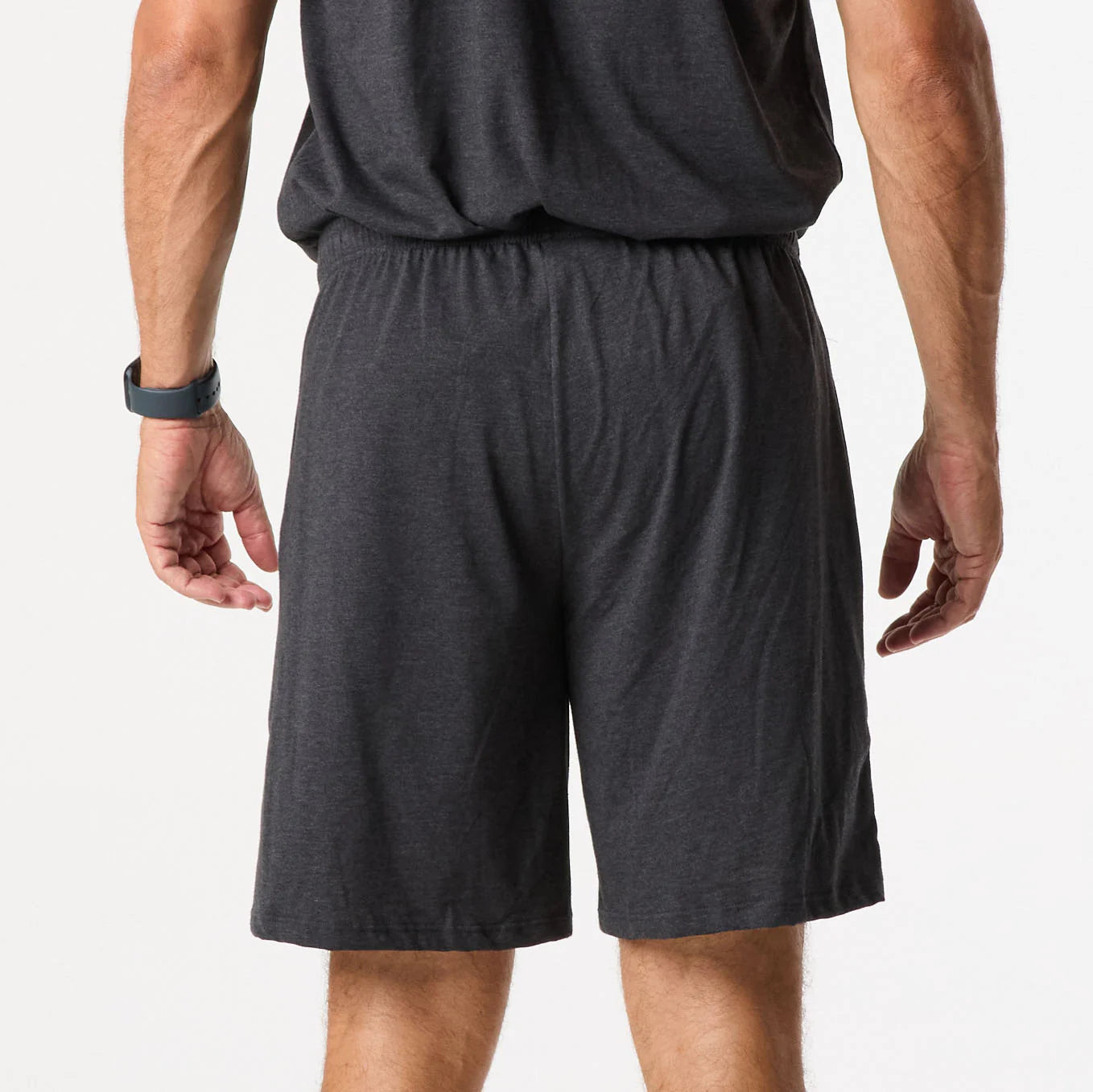 Someone models the DFND Sleepwear SS Shirt & Shorts in black, standing with their back to the camera against a plain white background.