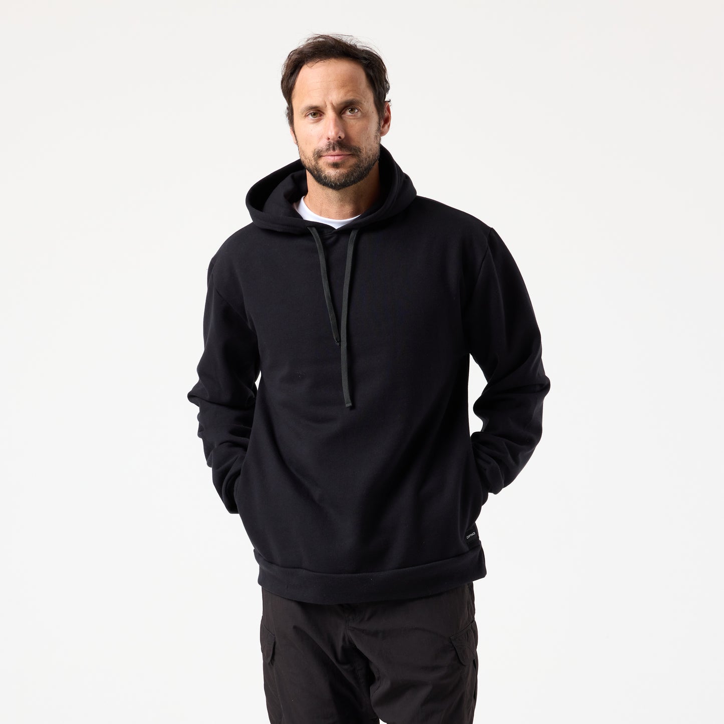 A man stands facing forward, wearing the DFND TITAN FLEECE HOOD and black pants—ideal for cold weather training—against a plain white background.
