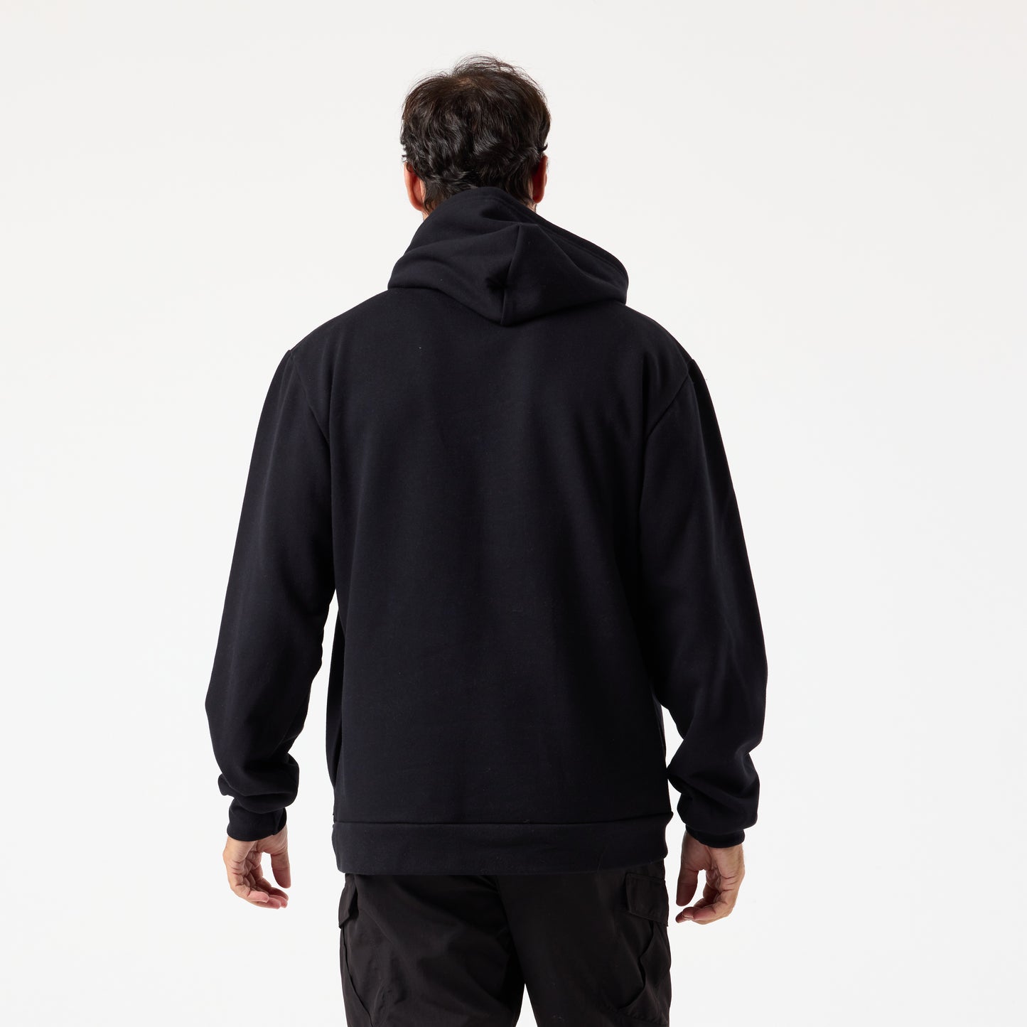 A person wearing the DFND TITAN FLEECE HOOD and black pants stands with their back to the camera against a plain white background, showcasing ideal cold weather training apparel.