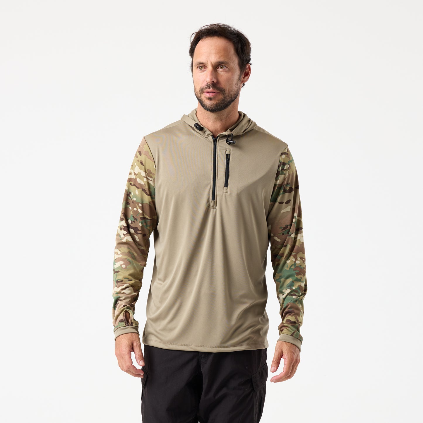 A man models the DFND SPEED TECH HOODED 1/4 ZIP, a lightweight performance shirt with a light brown hood and camo sleeves, paired with black pants, posed against a plain white background.