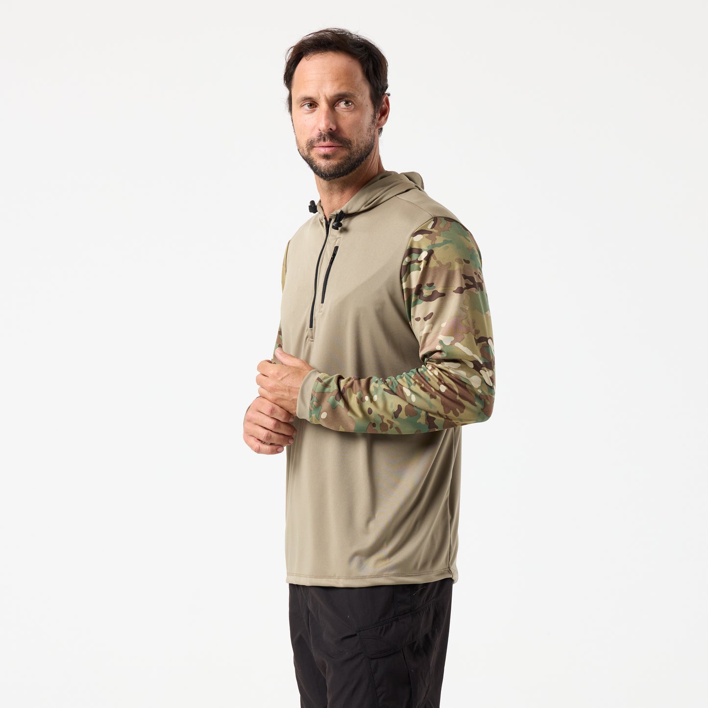 Man wearing the DFND SPEED TECH HOODED 1/4 ZIP performance shirt with camouflage sleeves and black pants, standing against a plain white background.