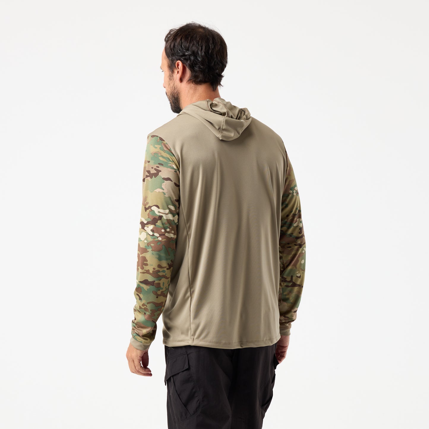A man, facing away, stands against a white background wearing the DFND SPEED TECH HOODED 1/4 ZIP with camouflage sleeves and black pants.
