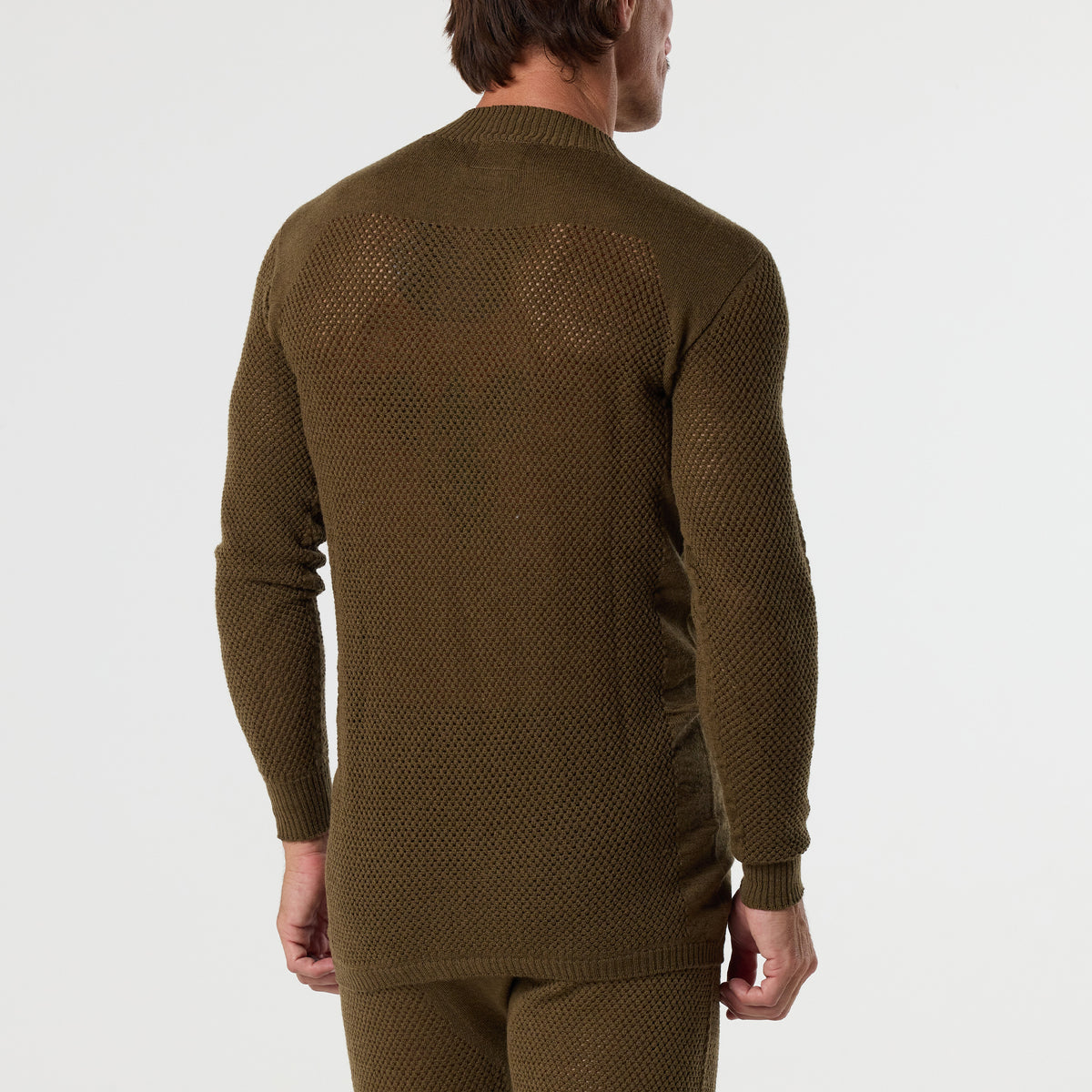 A man is shown from the back against a plain white background wearing the DFND TAHOE WOOL MESH LONG SLEEVE SHIRT in textured olive green, paired with matching pants, designed for cold weather performance.