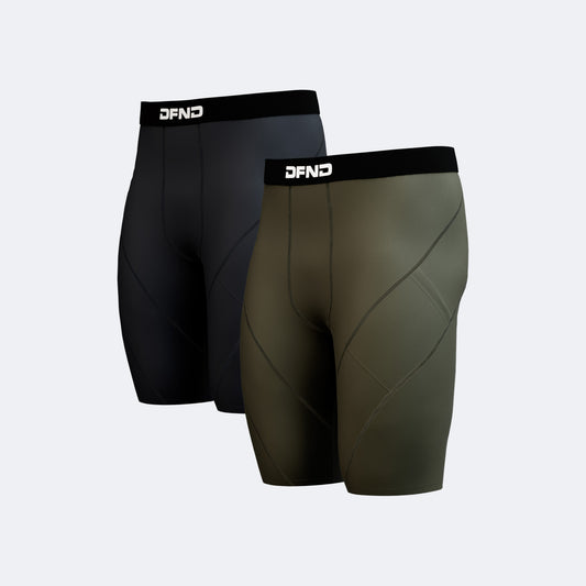 The DFND Compression Short 2-Pack features two pairs in black and olive green, each with a black waistband and "DFND" branding. Designed for performance support, they're displayed on a light gray background.