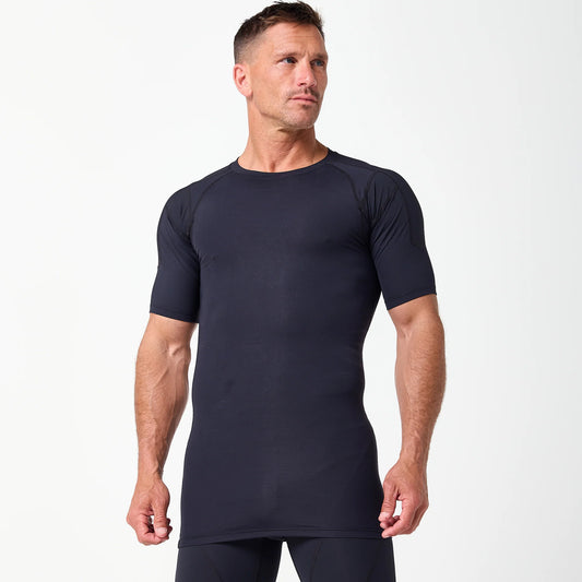 A man models the DFND Compression Short + Shirt Gym Kit, a black fitted athletic set with graduated compression, against a plain white background.